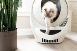 Cat exiting a Litter Robot 3, stepping onto the step mat