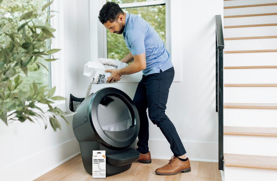 man refilling LitterHopper on Litter-Robot 4